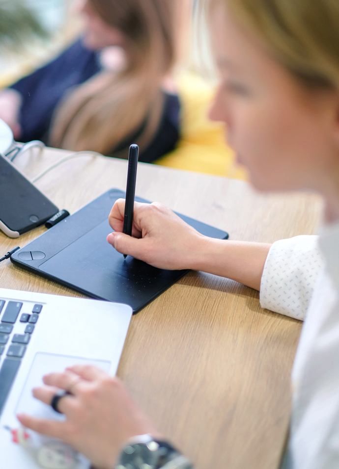 Advertising agency designer using a graphics tablet to create advert artwork