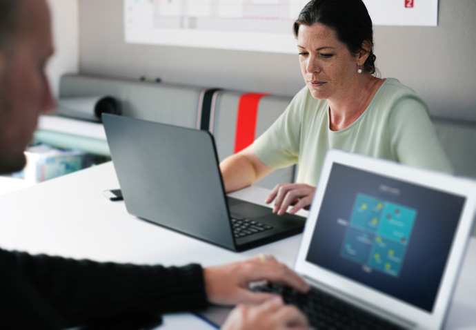 Branding agency team reviewing a brand positioning diagram on a laptop during a planning session