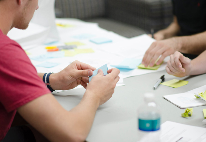 Branding agency team using sticky notes to plan during a branding workshop with a client