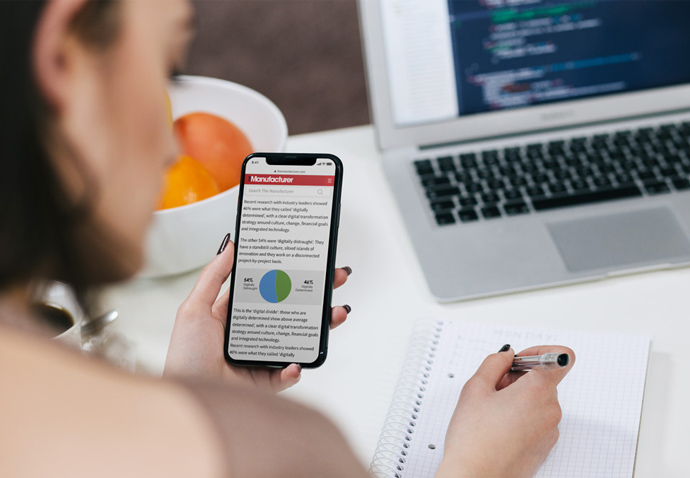 PR agency team member taking notes from a trade pubication website on a mobile device during the content production process