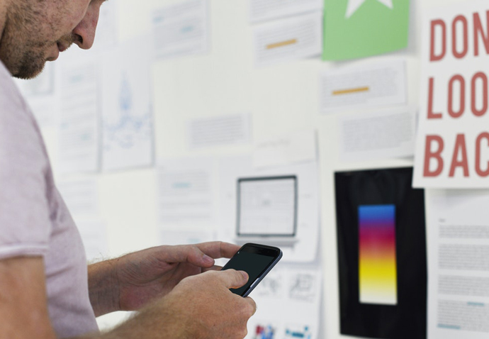 Agency team member stood next to board filled with notes during a marketing planning workshop