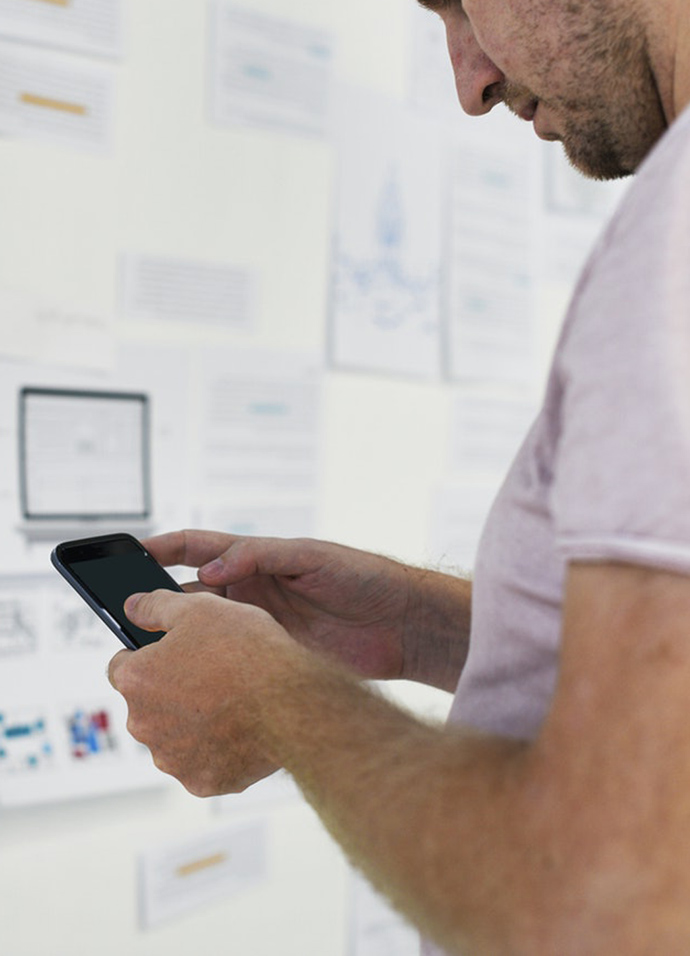 Marketer taking notes on a planning wall during a web design and build planning workshop